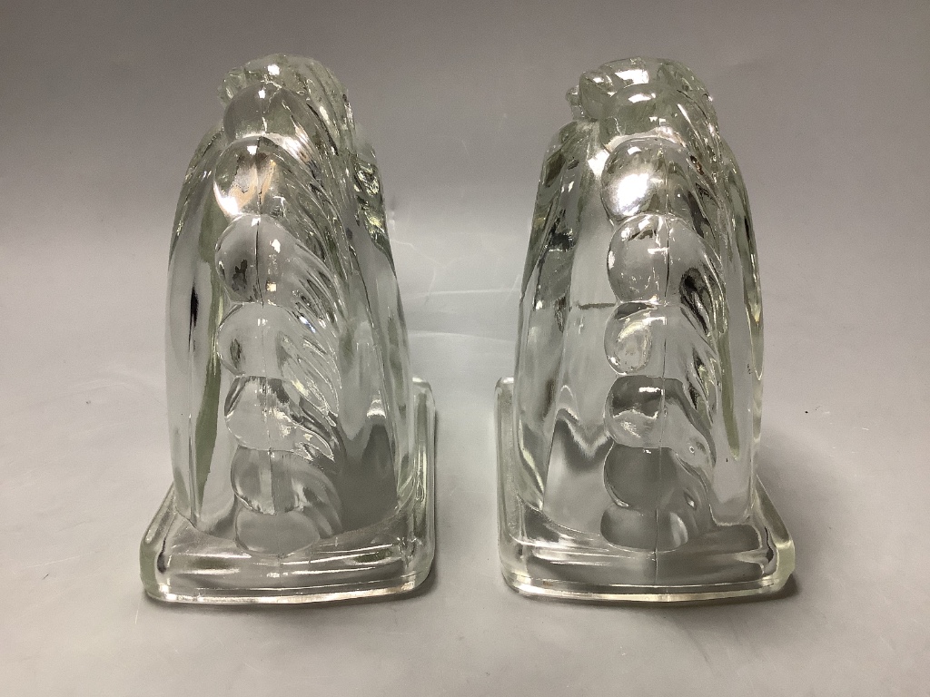 A pair of American press moulded glass horse head bookends, height 14cm